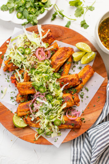 These Vegan Soft Rolled Tacos are a combo of taquitos and enchiladas. Filled with beans & veggies and brushed with enchilada sauce | ThisSavoryVegan.com #thissavoryvegan #vegantaquitos #rolledtacos