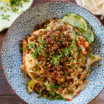 This Sichuan Tahini Noodle Stir-Fry is filled with veggies, noodles & a creamy sauce. It is then topped with crispy vegan beef crumbles and cilantro | ThisSavoryVegan.com #thissavoryvegan #vegannoodles #veganstirfry