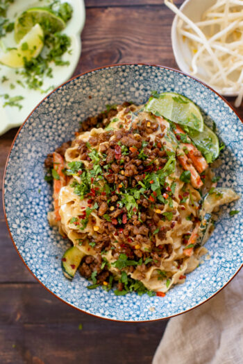 This Sichuan Tahini Noodle Stir-Fry is filled with veggies, noodles & a creamy sauce. It is then topped with crispy vegan beef crumbles and cilantro | ThisSavoryVegan.com #thissavoryvegan #vegannoodles #veganstirfry