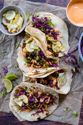 These Vegan Korean Beef Tacos are layered with seasoned vegan "beef", pickled zucchini, crunchy slaw and spicy mayo | ThisSavoryVegan.com #thissavoryvegan #vegantacos #koreantacos