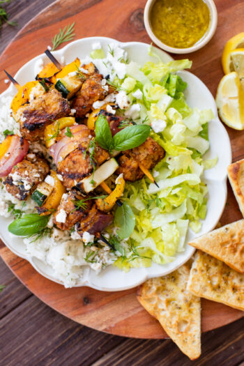 These Greek Tempeh Skewer Bowls are the perfect summer meal! Marinated tempeh is grilled until crispy & served with vegan feta dressing and herbed rice | ThisSavoryVegan