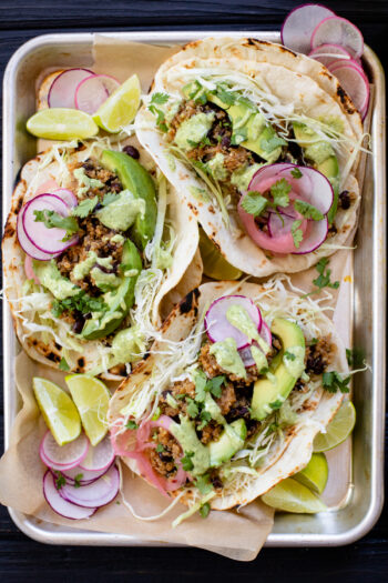 These Black Bean Quinoa Tacos are a one-skillet dinner that are high in fiber & protein. Served with a dairy-free cilantro yogurt sauce | ThisSavoryVegan.com #thissavoryvegan #vegantacos #quinoatacos