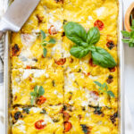 This Sheet Pan Vegan Frittata is made with all of your favorite mediterranean flavors -vegan feta, sautéed tomatoes, sun-dried tomatoes & basil | ThisSavoryVegan.com #thissavoryvegan #veganbreakfast #veganbrunch