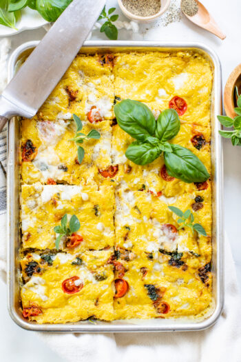This Sheet Pan Vegan Frittata is made with all of your favorite mediterranean flavors -vegan feta, sautéed tomatoes, sun-dried tomatoes & basil | ThisSavoryVegan.com #thissavoryvegan #veganbreakfast #veganbrunch