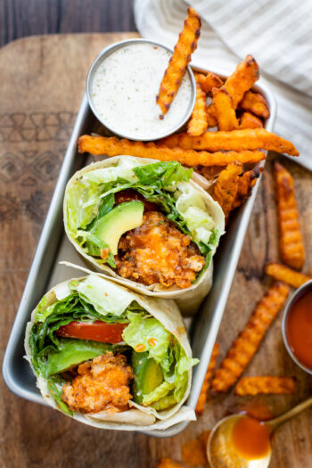 These Vegan Buffalo Sriracha Chicken Wraps are the perfect on the go lunch. Soy curl chicken wings, non-dairy caesar dressing, avocado and veggies | ThisSavoryVegan.com #thissavoryvegan #veganchicken #veganwrapideas