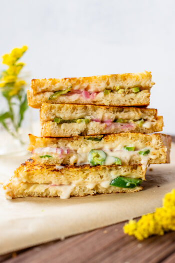 This Vegan Jalapeño Popper Grilled Cheese is the ultimate comfort food. Coated in vegan parmesan and filled with spicy jalapeños & red onion | ThisSavoryVegan.com #thissavoryvegan #vegangrilledcheese #vegansandwich