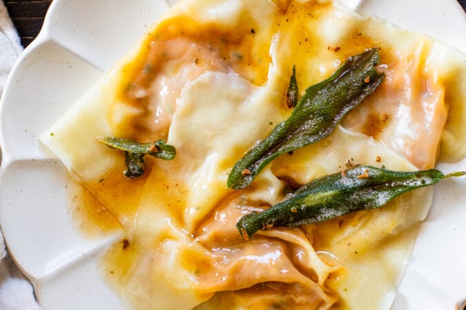 These Vegan Pumpkin Wonton Ravioli are the perfect Fall dinner. Made simple by using wonton wrappers and served up with a brown butter sage sauce | ThisSavoryVegan.com #thissavoryvegan #pumpkinravioli #veganravioli #wontonravioli