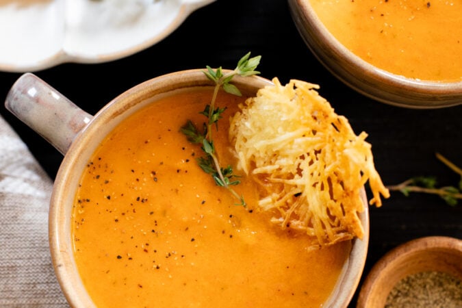 This Butternut Squash Tomato Soup is creamy and delicious - made with roasted veggies and served with vegan parmesan crisps | ThisSavoryVegan.com #thissavoryvegan #vegansoup #fallrecipes