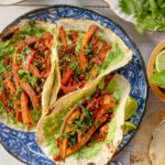 These Sweet Potato Soyrizo Tacos have roasted veggies, crispy soyrizo and a creamy vegan jalapeño yogurt sauce. Perfect for taco Tuesday | ThisSavoryVegan.com #thissavoryvegan #vegantacos #potatotacos