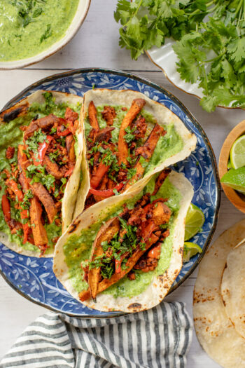 These Sweet Potato Soyrizo Tacos have roasted veggies, crispy soyrizo and a creamy vegan jalapeño yogurt sauce. Perfect for taco Tuesday | ThisSavoryVegan.com #thissavoryvegan #vegantacos #potatotacos