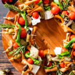 This Christmas Antipasto Wreath is the perfect holiday appetizer! Loaded with vegan cheese, vegan pepperoni, olives, artichoke hearts & basil | ThisSavoryVegan.com #thissavoryvegan #christmasrecipes #holidayappetizers