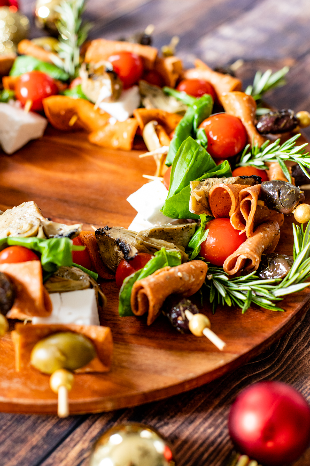 This Christmas Antipasto Wreath is the perfect holiday appetizer! Loaded with vegan cheese, vegan pepperoni, olives, artichoke hearts & basil | ThisSavoryVegan.com #thissavoryvegan #christmasrecipes #holidayappetizers