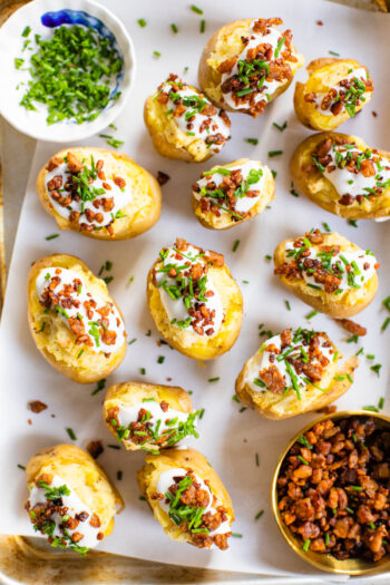 These Mini Baked Potatoes are the perfect party appetizer! Loaded with vegan cream cheese and topped with crispy tempeh bacon | ThisSavoryVegan.com #thissavoryvegan #holidayappetizers #veganappetizers