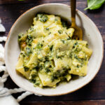 This vegan Feta Spinach Mac & Cheese is creamy, comforting a delicious. Made with vegan feta & pesto and topped with breadcrumbs | ThisSavoryVegan.com #thissavoryvegan #veganpasta #veganmacandcheese