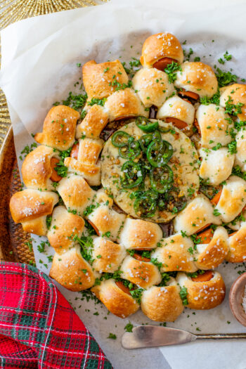 This Pigs in a Blanket Wreath is made with crescent dough & vegan hot dogs. Served with warm vegan cheese and a jalapeño agave glaze | ThisSavoryVegan.com #thissavoryvegan #holidayappetizers #christmasappetizers