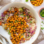 This Sesame Cabbage Salad is layered with shredded cabbage, carrots, green onion, cilantro, crispy chickpeas and a creamy sesame dressing | ThisSavoryVegan.com #thissavoryvegan #cabbagerecipes #chickpearecipes