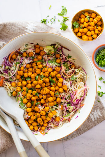 This Sesame Cabbage Salad is layered with shredded cabbage, carrots, green onion, cilantro, crispy chickpeas and a creamy sesame dressing | ThisSavoryVegan.com #thissavoryvegan #cabbagerecipes #chickpearecipes