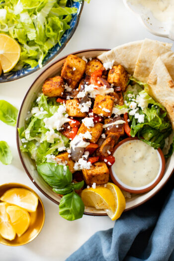 This Greek Tofu & Veggies recipe is full-proof. Marinated tofu is baked until crispy and served with a non-dairy lemon yogurt sauce | ThisSavoryVegan.com #thissavoryvegan #tofurecipe #greektofu
