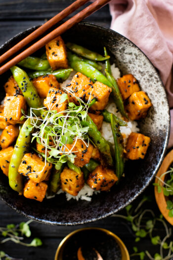 Hoisin Tofu Rice Bowls are a mix of crispy tofu, snap peas, rice and a delicious homemade sauce. The perfect plant based tofu bowl | ThisSavoryVegan.com #thissavoryvegan #tofurecipes #tofubowl
