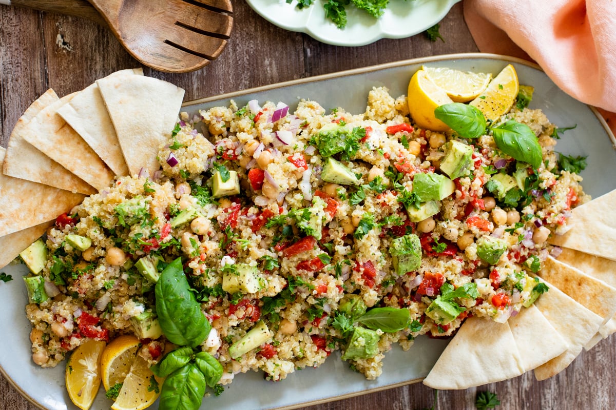 This Mediterranean Quinoa Salad is a healthy and easy meal - filled with quinoa, avocado, roasted red peppers, chickpeas & vegan feta | ThisSavoryVegan.com #thissavoryvegan #quinoasalad #saladrecipes