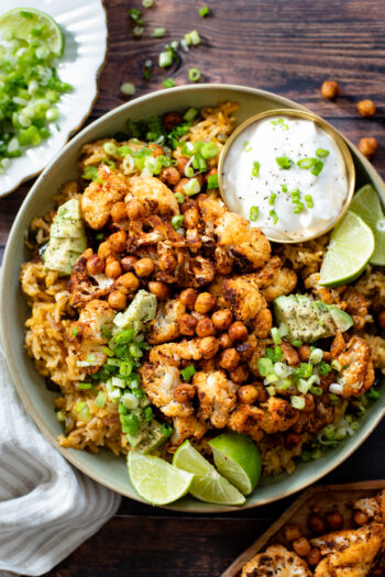 This Roasted Cauliflower & Salsa Verde Rice is an amazing plant based dinner! Flavor-packed rice, crispy cauliflower & chickpeas | ThisSavoryVegan.com #thissavoryvegan #cauliflowerrecipes #plantbased
