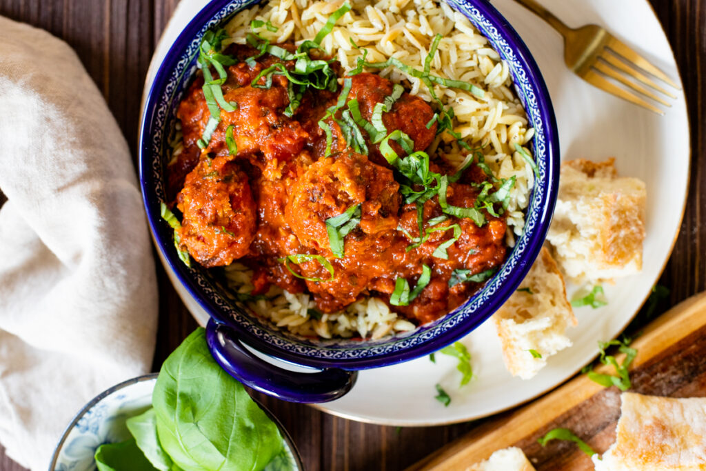 These Vegan Turkey Meatballs & Orzo are the best vegan dinner! Meatballs are simmered in marinara sauce before being served over garlic basil orzo | ThisSavoryVegan.com #thissavoryvegan #veganmeatballs #easyvegandinner