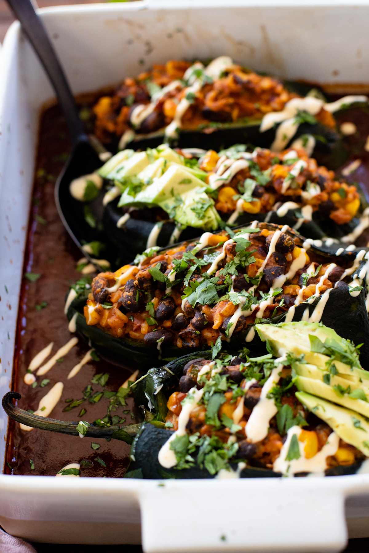 These Veggie Stuffed Poblano Peppers are filled with brown rice, black beans & veggies that are cooked down in enchilada sauce | ThisSavoryVegan.com #thissavoryvegan #stuffedpeppers #vegandinnerideas