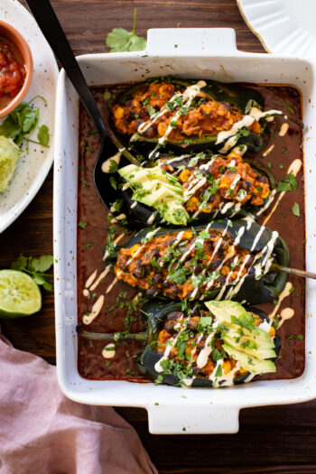 These Veggie Stuffed Poblano Peppers are filled with brown rice, black beans & veggies that are cooked down in enchilada sauce | ThisSavoryVegan.com #thissavoryvegan #stuffedpeppers #vegandinnerideas