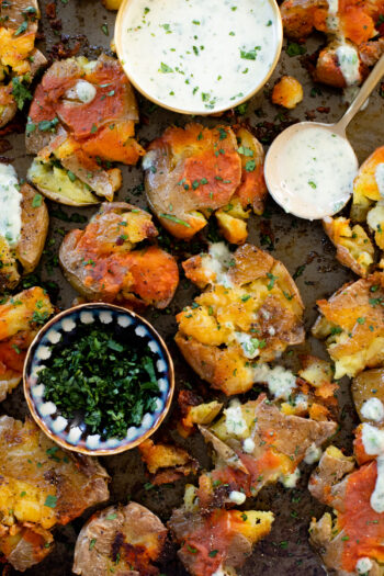 These Buffalo Smashed Potatoes are baked on a sheet pan until crispy, drizzled with buffalo sauce and served with vegan cilantro ranch | ThisSavoryVegan.com #thissavoryvegan #potatoreccipes #veganappetizers