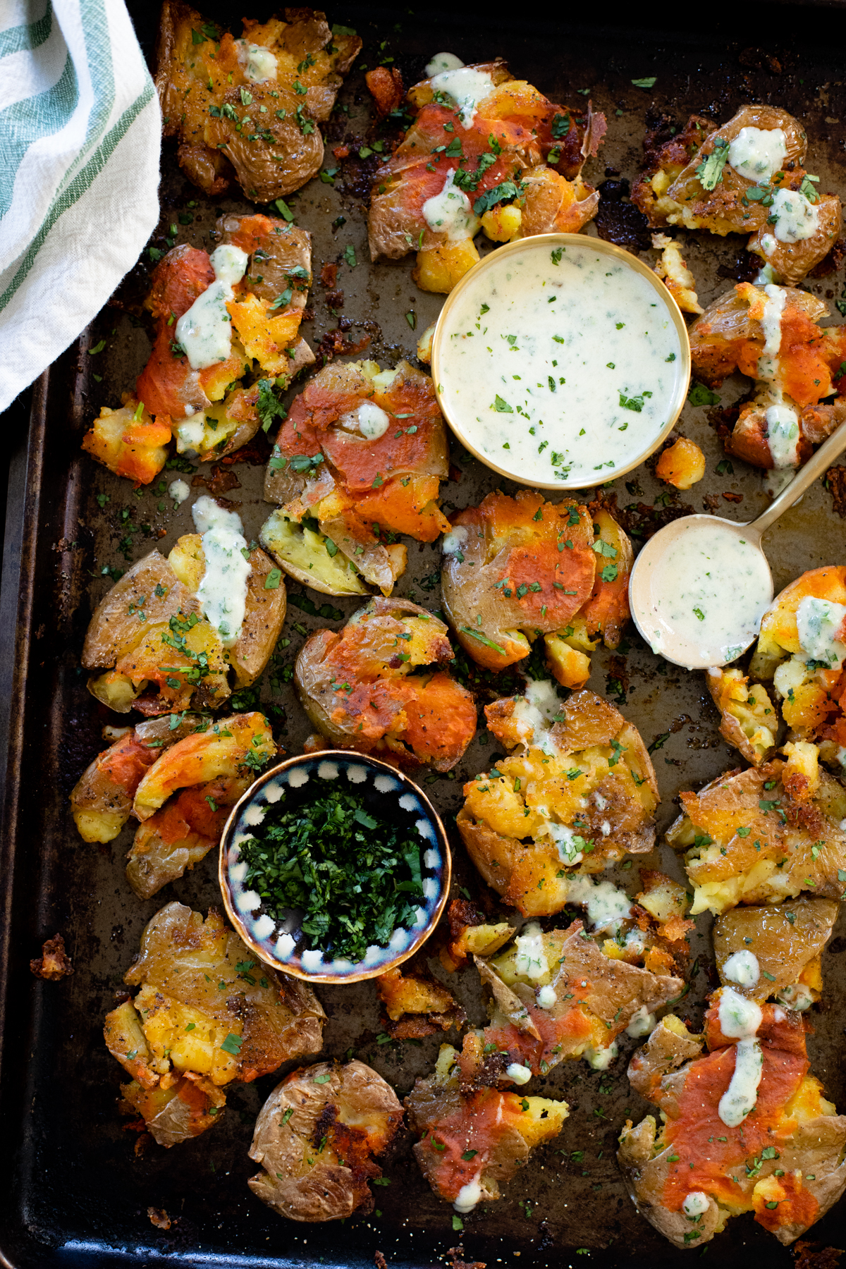 These Buffalo Smashed Potatoes are baked on a sheet pan until crispy, drizzled with buffalo sauce and served with vegan cilantro ranch | ThisSavoryVegan.com #thissavoryvegan #potatoreccipes #veganappetizers