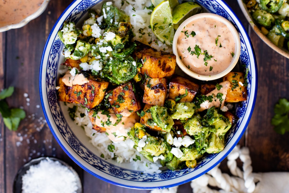 These Chipotle Agave Tofu Bowls have marinated & baked tofu, steamed rice and a avocado jalapeño salsa. The perfect vegan dinner | ThisSavoryVegan.com #thissavoryvegan #tofurecipes #vegandinnerideas