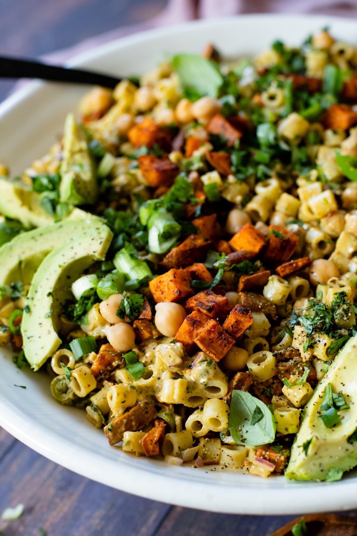 This Chipotle Sweet Potato Pasta Salad is filled with roasted sweet potato, chickpeas, pasta, red onion, cilantro & a creamy vegan chipotle dressing | ThisSavoryVegan.com #thissavoryvegan #pastasalad #summerrecipes