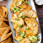 These Crispy Refried Bean Tacos have a simple refried bean & green chile filling. They are served with avocado & chipotle mayo | ThisSavoryVegan.com #thissavoryvegan #vegantacos #beantacos