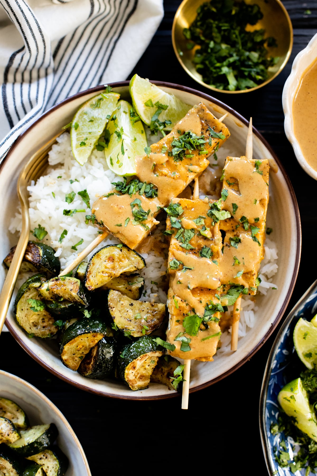 These Peanut Tofu Skewer Bowls have grilled tofu, rice, roasted zucchini and the BEST peanut sauce. This is the ultimate vegan dinner | ThisSavoryVegan.com #thissavoryvegan #peanuttofu #tofurecipes