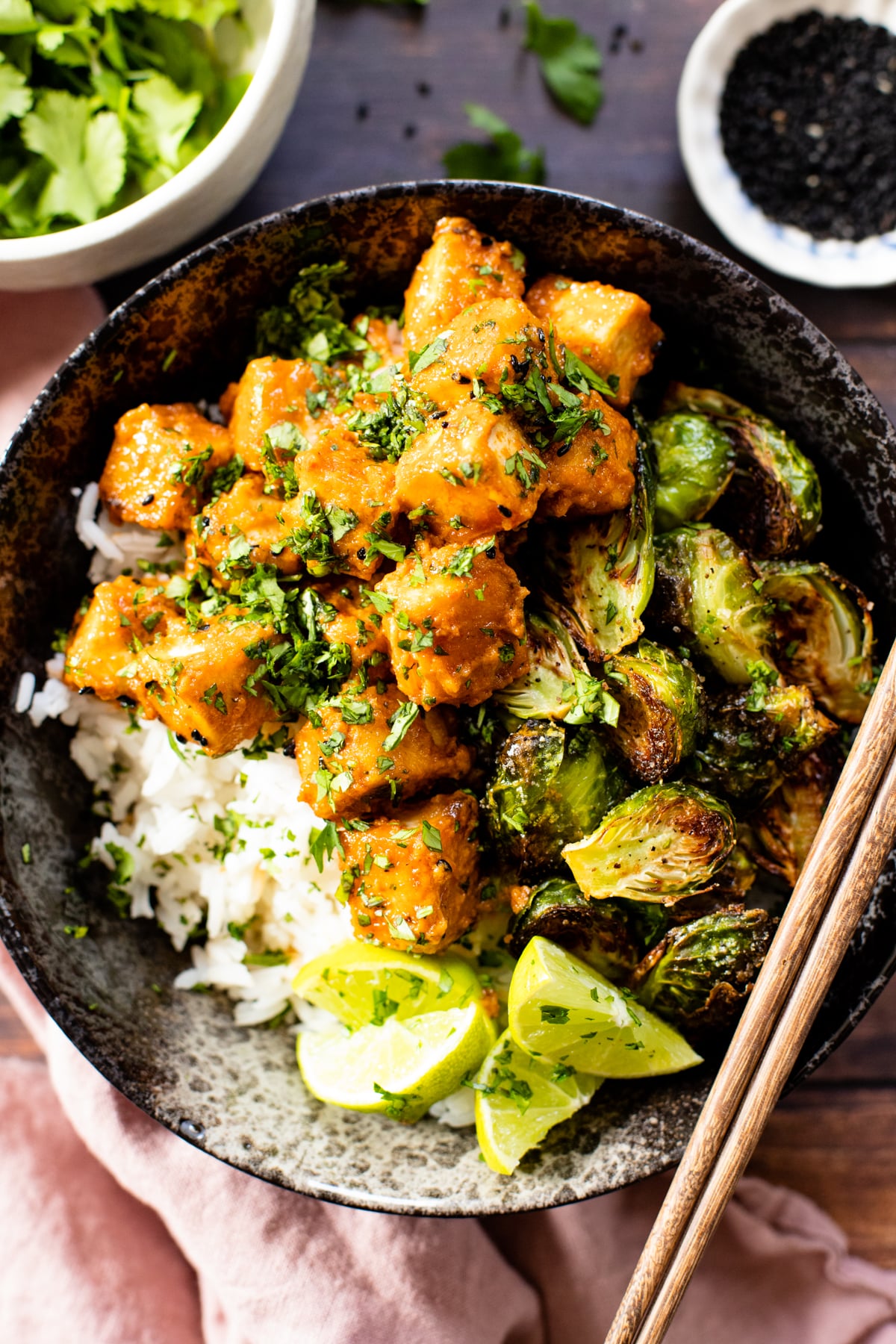 These Red Curry Tofu Bowls have a coconut red curry sauce, crispy tofu, roasted brussels sprouts and rice. An easy vegan dinner | ThisSavoryVegan.com #thissavoryvegan #tofurecipes #vegandinnerideas