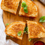 These Red Pepper Pesto Sandwiches are made with vegan cream cheese, arugula, avocado & a homemade roasted red pepper pesto | ThisSavoryVegan.com #thissavoryvegan #sandwiches #veganpesto