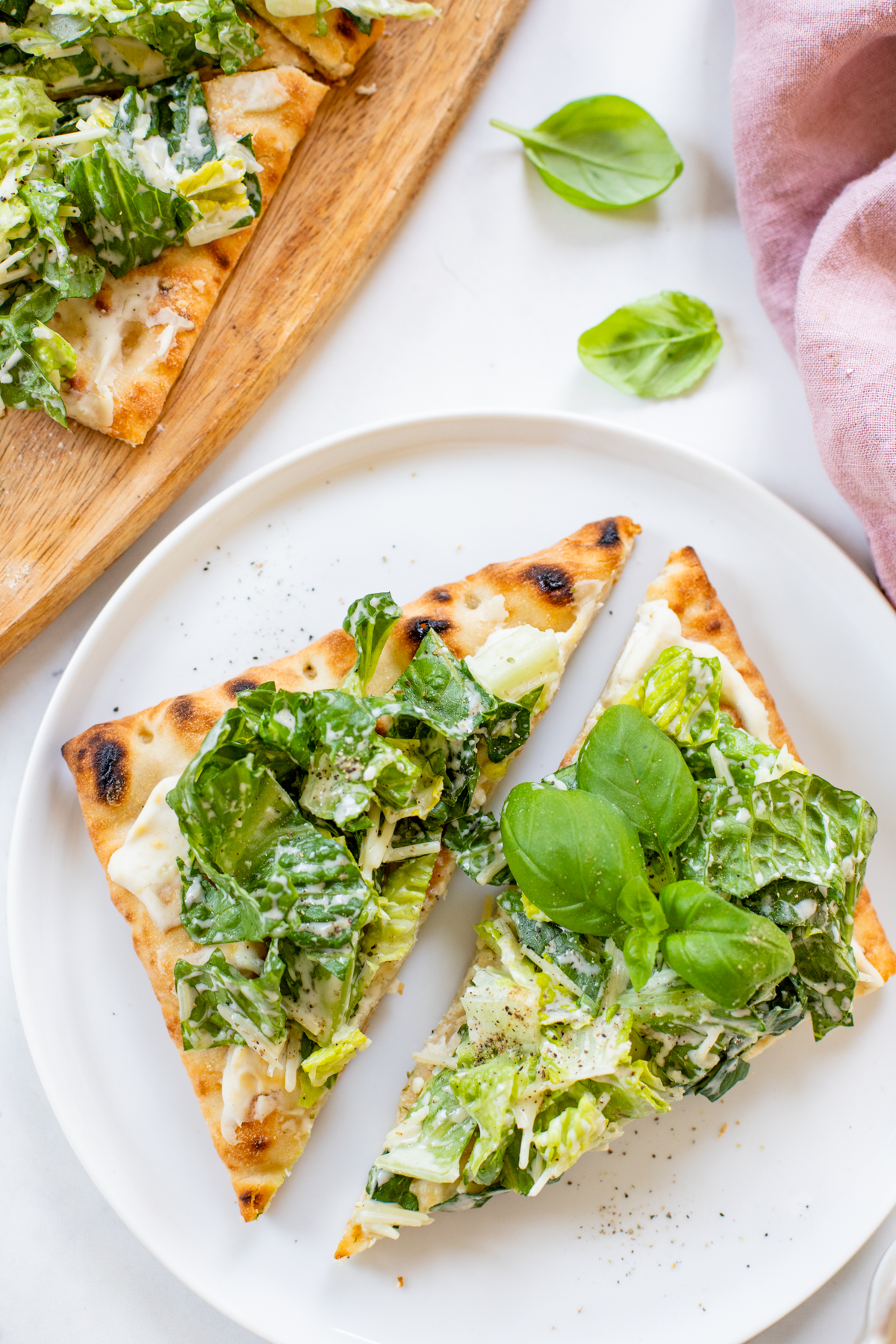 This Caesar Salad Pizza is the perfect combo - crispy pizza crust coated in vegan cream cheese and topped with the best dairy-free caesar salad | ThisSavoryVegan.com #thissavoryvegan #saladpizza #veganpizza