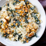 This Kale Caesar Pasta Salad is dairy-free and absolutely delicious! Fresh kale, chilled farfalle, vegan parmesan, roasted chickpeas, homemade ciabatta croutons & creamy caesar dressing | ThisSavoryVegan.com #thissavoryvegan #pastasalad #summerrecipes