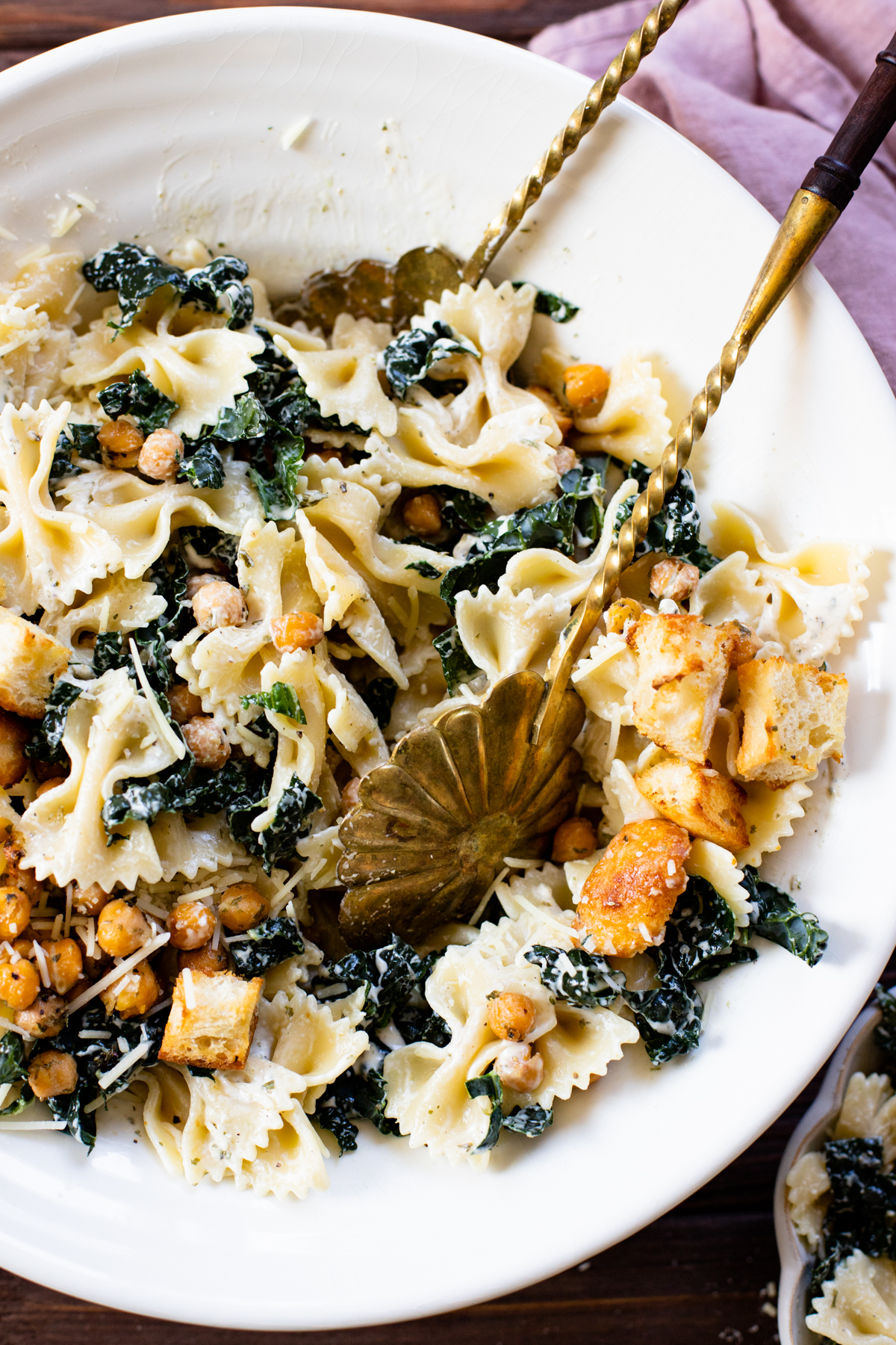 This Kale Caesar Pasta Salad is dairy-free and absolutely delicious! Fresh kale, chilled farfalle, vegan parmesan, roasted chickpeas, homemade ciabatta croutons & creamy caesar dressing | ThisSavoryVegan.com #thissavoryvegan #pastasalad #summerrecipes