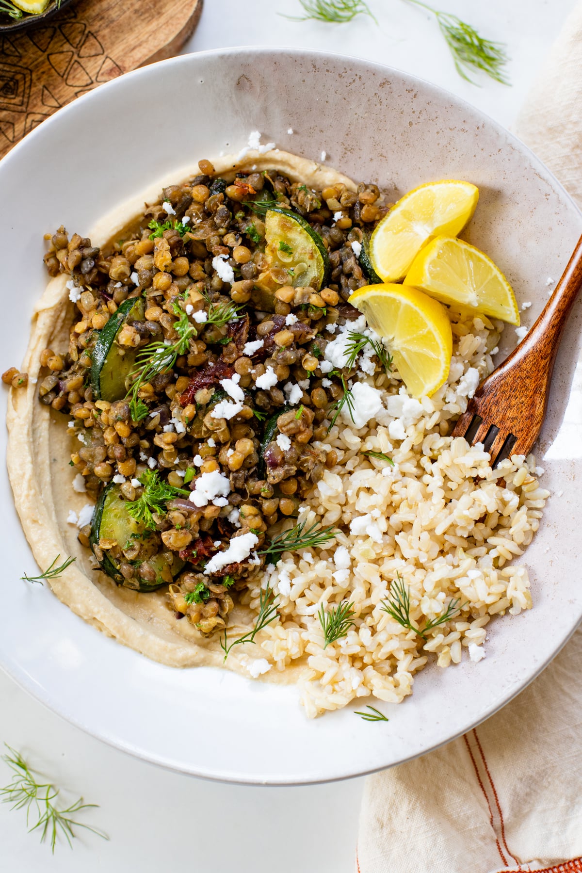 These Mediterranean Lentil Grain Bowls are layered with hummus, brown rice, lentils & veggies. The perfect vegan meal prep lunch or dinner | ThisSavoryVegan.com #thissavoryvegan #grainbowl #lentilrecipes