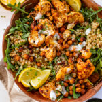 This Roasted Cauliflower Couscous Salad has crispy cauliflower & chickpeas, seasoned pearl couscous, arugula & vegan yogurt dressing | ThisSavoryVegan.com #thissavoryvegan #summersalad #springrecipes