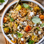 This Roasted Tomato Farro Salad is filled with slow roasted cherry tomatoes, farro, vegan feta, shallots and a red wine vinegar dressing | ThisSavoryVegan.com #thissavoryvegan #springsalads #farrorecipes