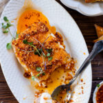 This Pan-Fried Vegan Feta is the most indulgent appetizer. Vegan feta is coated in panko, pan fried and topped with chili onion crunch | ThisSavoryVegan.com #thissavoryvegan #veganappetizers #vegancheese