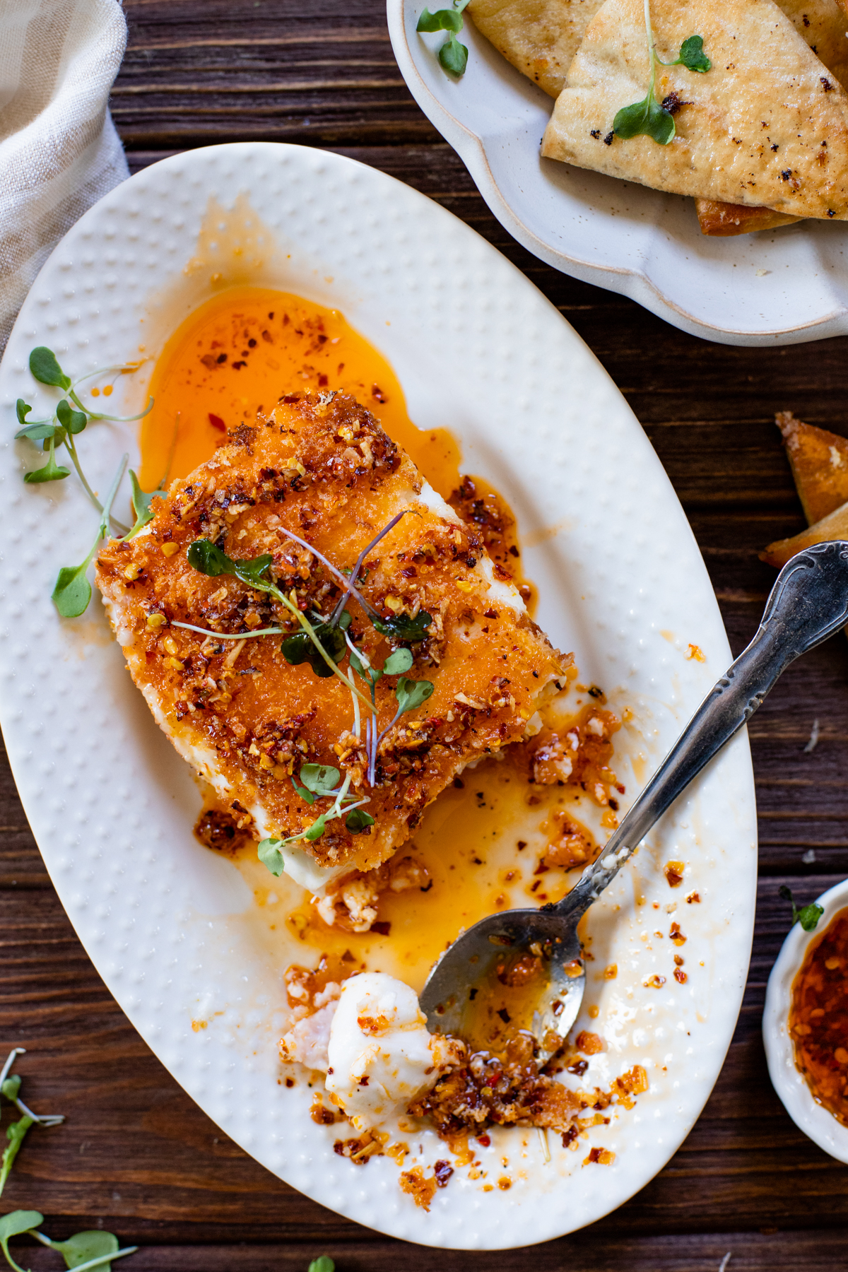 This Pan-Fried Vegan Feta is the most indulgent appetizer. Vegan feta is coated in panko, pan fried and topped with chili onion crunch | ThisSavoryVegan.com #thissavoryvegan #veganappetizers #vegancheese