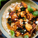 This Roasted Cauliflower with Maple Jalapeño Glaze is layered with hummus, crispy cauliflower, vegan feta, fresh herbs & sticky jalapeño sauce | ThisSavoryVegan.com #thissavoryvegan #cauliflowerrecipes #vegansnacks