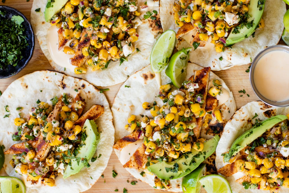 These Vegan Street Corn Tacos are filled with grilled tofu, street corn salad, avocado slices and a spicy mayo. Easy, delicious vegan tacos | ThisSavoryVegan.com #thissavoryvegan #vegantacos #mexicanstreetcorn