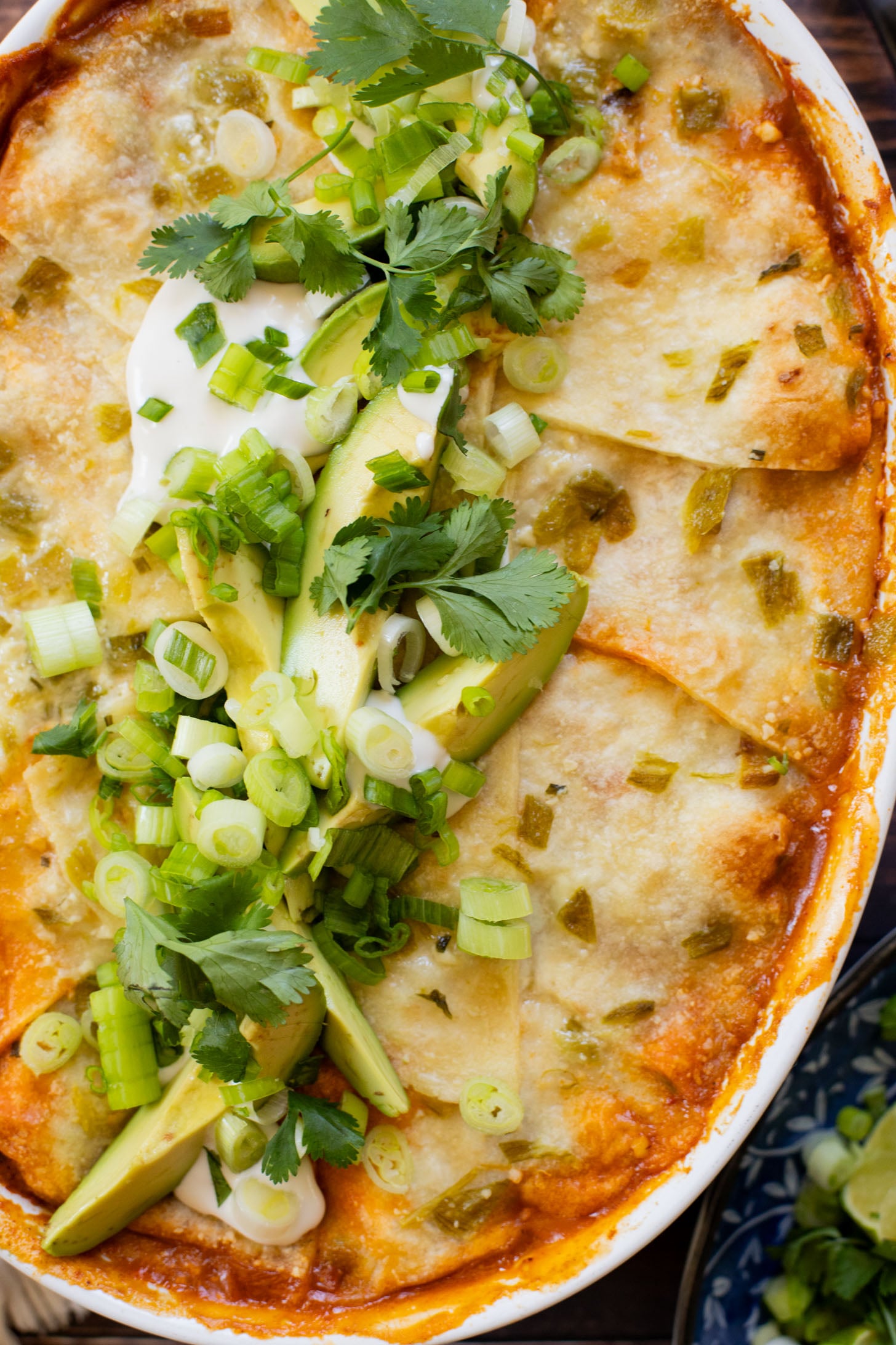 This vegan Green Chile Enchilada Casserole is made with a dairy-free sour cream sauce, lots of veggies, soyrizo, beans and flour tortillas | ThisSavoryVegan.com #thissavoryvegan #veganenchiladas #dairyfreeenchiladas