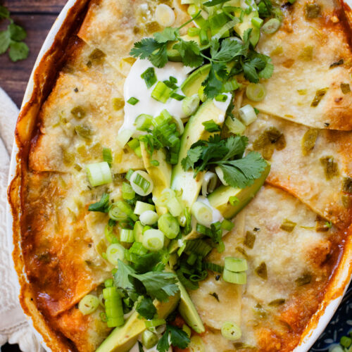 This vegan Green Chile Enchilada Casserole is made with a dairy-free sour cream sauce, lots of veggies, soyrizo, beans and flour tortillas | ThisSavoryVegan.com #thissavoryvegan #veganenchiladas #dairyfreeenchiladas