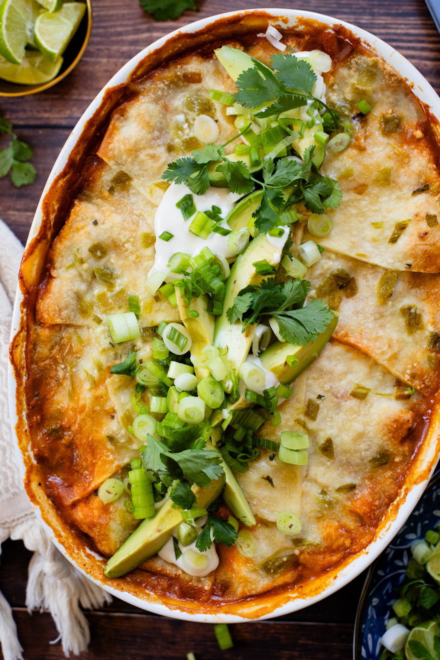 This vegan Green Chile Enchilada Casserole is made with a dairy-free sour cream sauce, lots of veggies, soyrizo, beans and flour tortillas | ThisSavoryVegan.com #thissavoryvegan #veganenchiladas #dairyfreeenchiladas