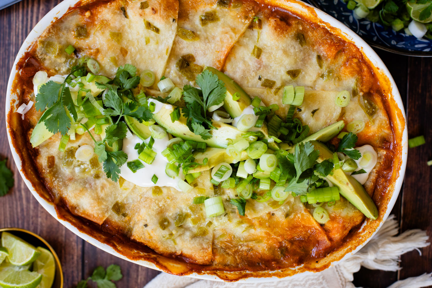 This vegan Green Chile Enchilada Casserole is made with a dairy-free sour cream sauce, lots of veggies, soyrizo, beans and flour tortillas | ThisSavoryVegan.com #thissavoryvegan #veganenchiladas #dairyfreeenchiladas
